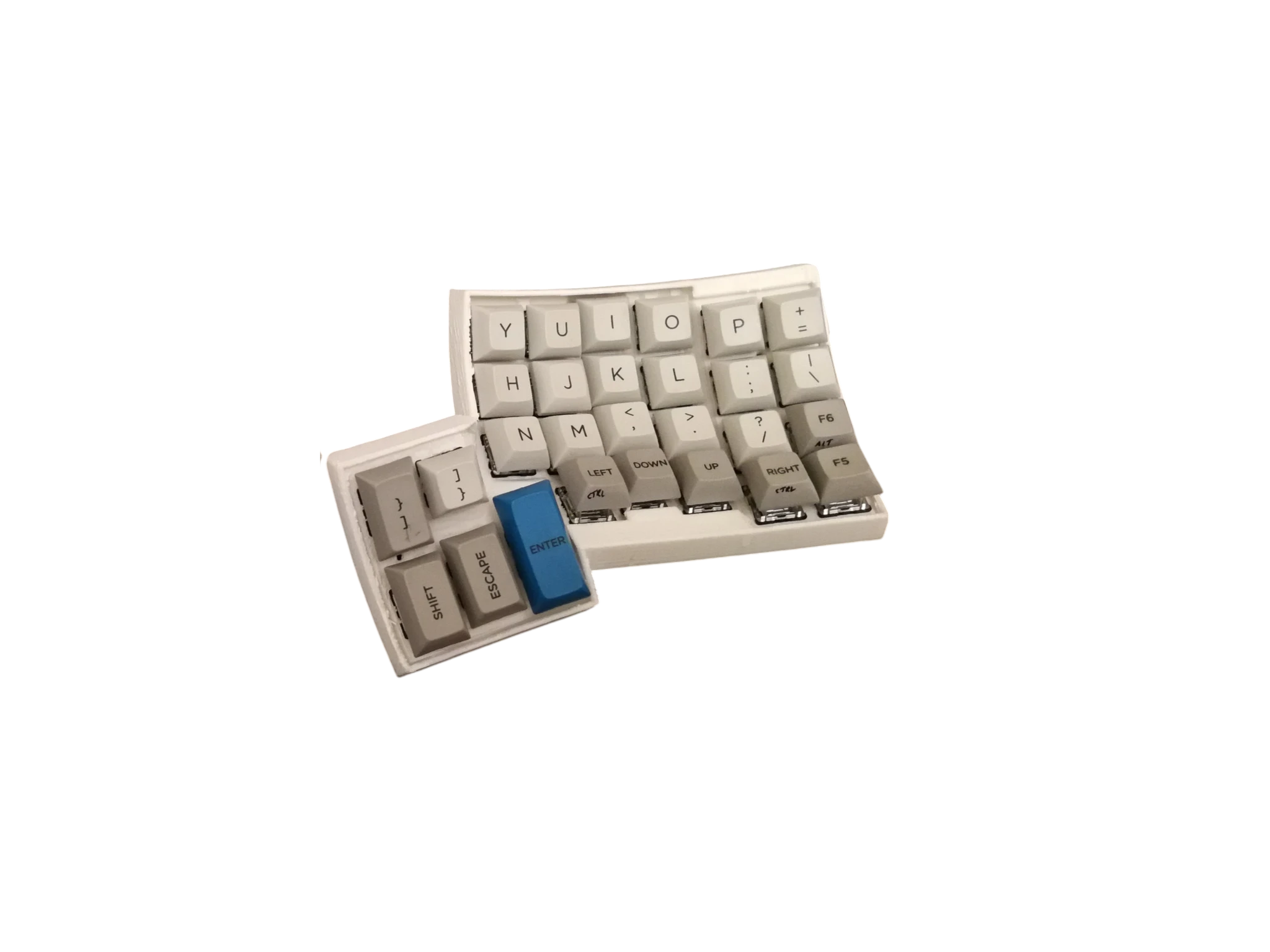 Custom keyboard with grey keycaps and a blue Enter key